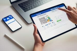 hand is pressing facebook screen scaled e1614954640138