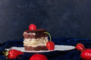 slice cake with cocoa strawberries scaled 1